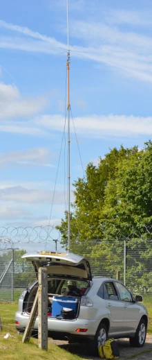 Car next to a radio mast